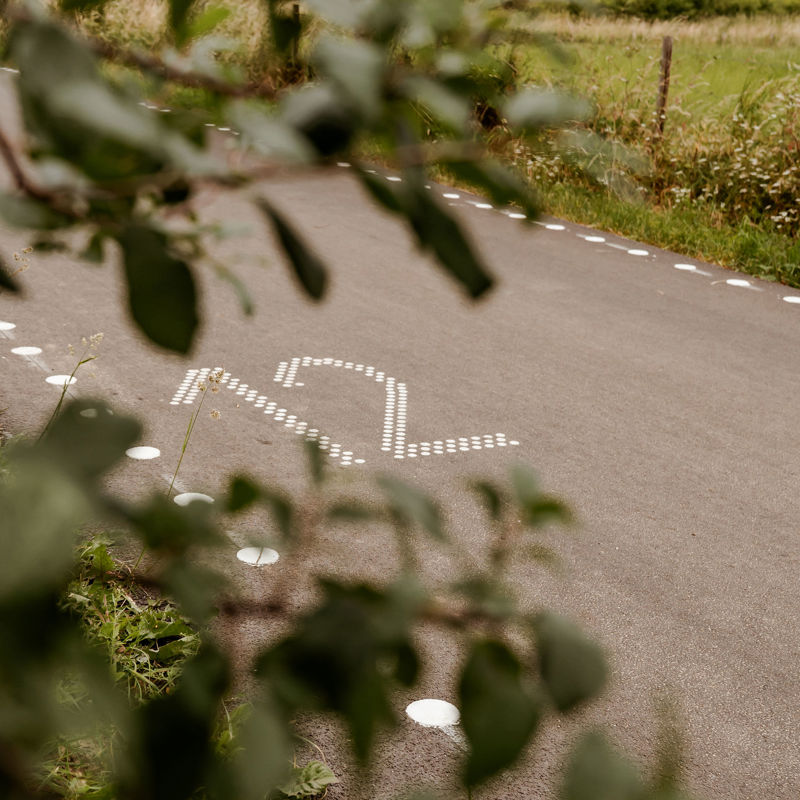 Gemarkeerde 12 op de weg, als kilometermarkering op de Parkstadroute. 